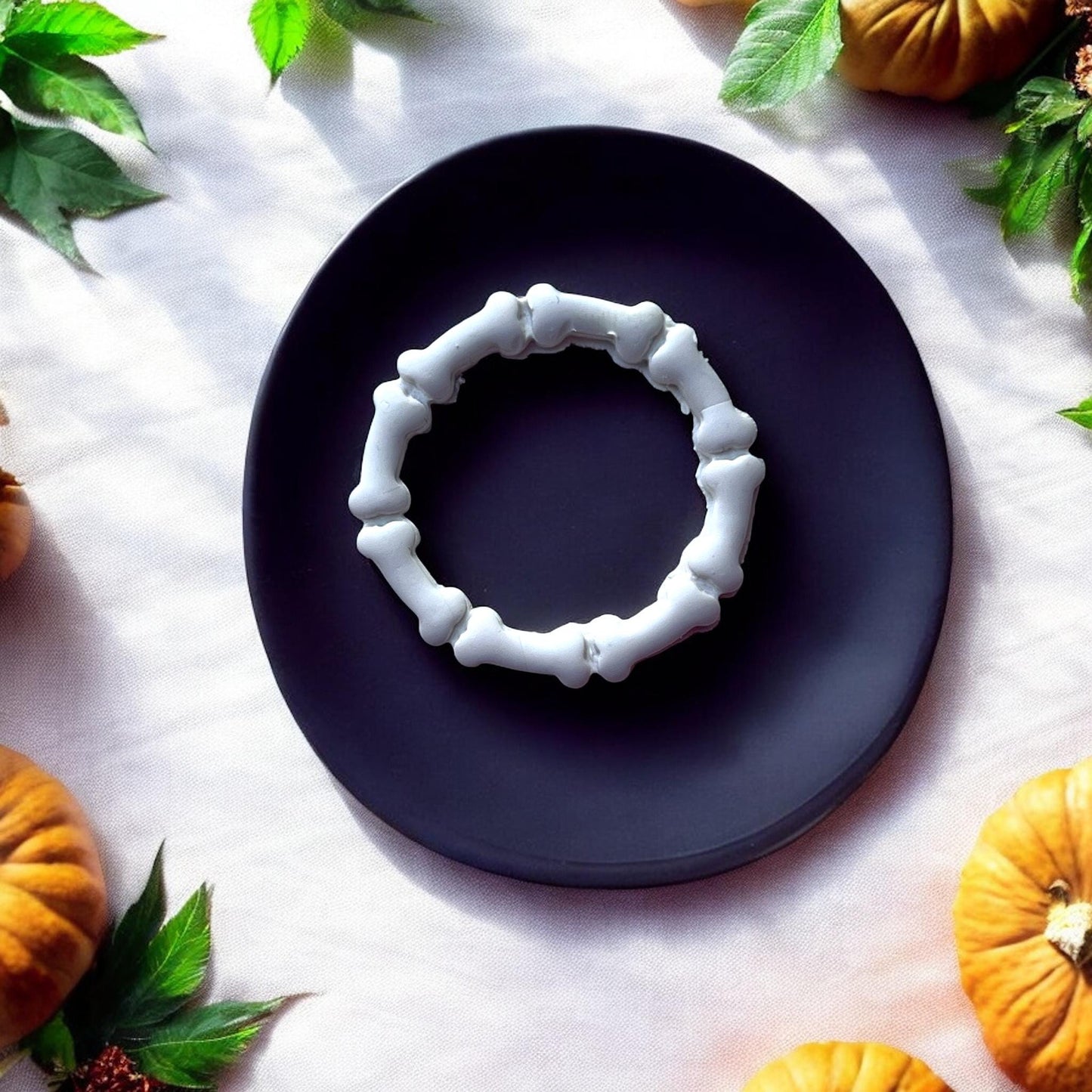 White bone wreath earring on black plate