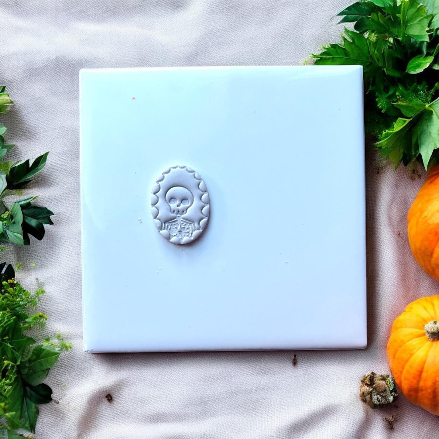 skeleton cameo clay shape on white tile