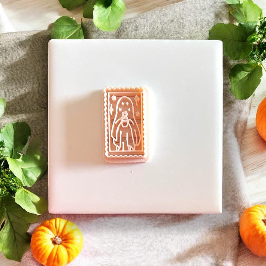 Clay impression of the ghost cameo stamp shown centered on a tile