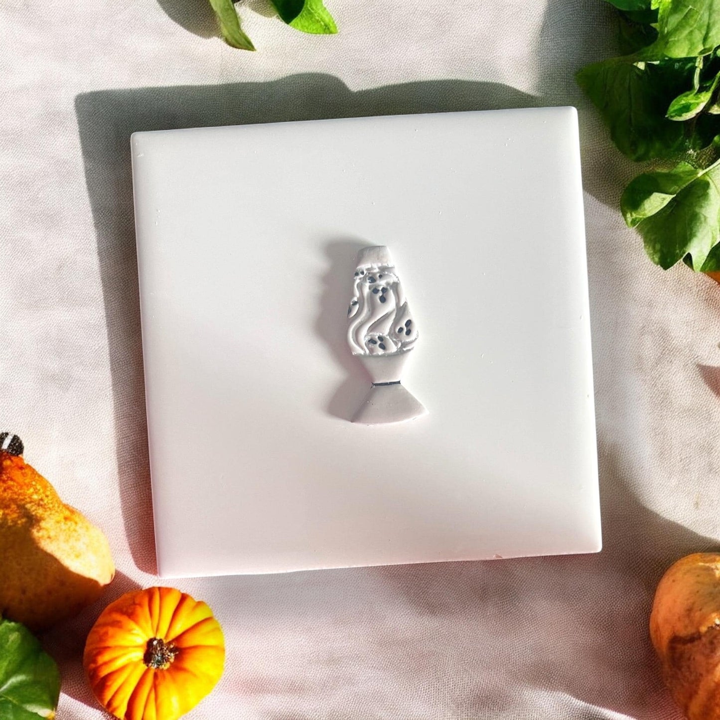 Finished clay shape of ghost lava lamp on white background