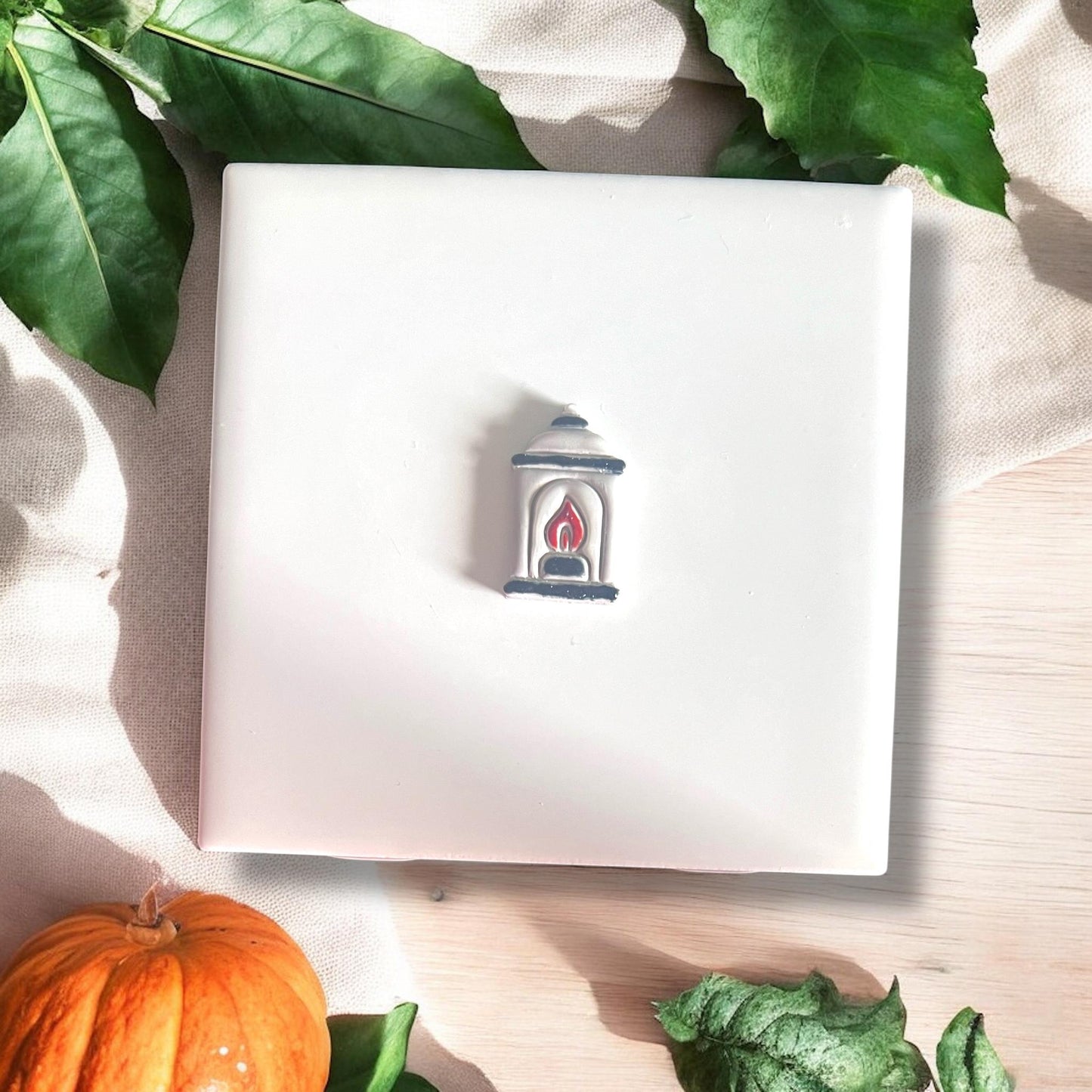 Painted lantern earring with red flame detail on white base