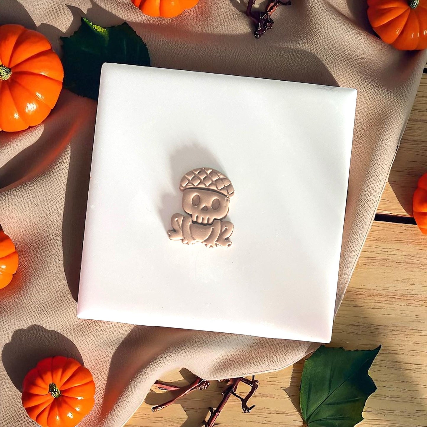 Halloween frog skeleton cutter surrounded by mini pumpkins