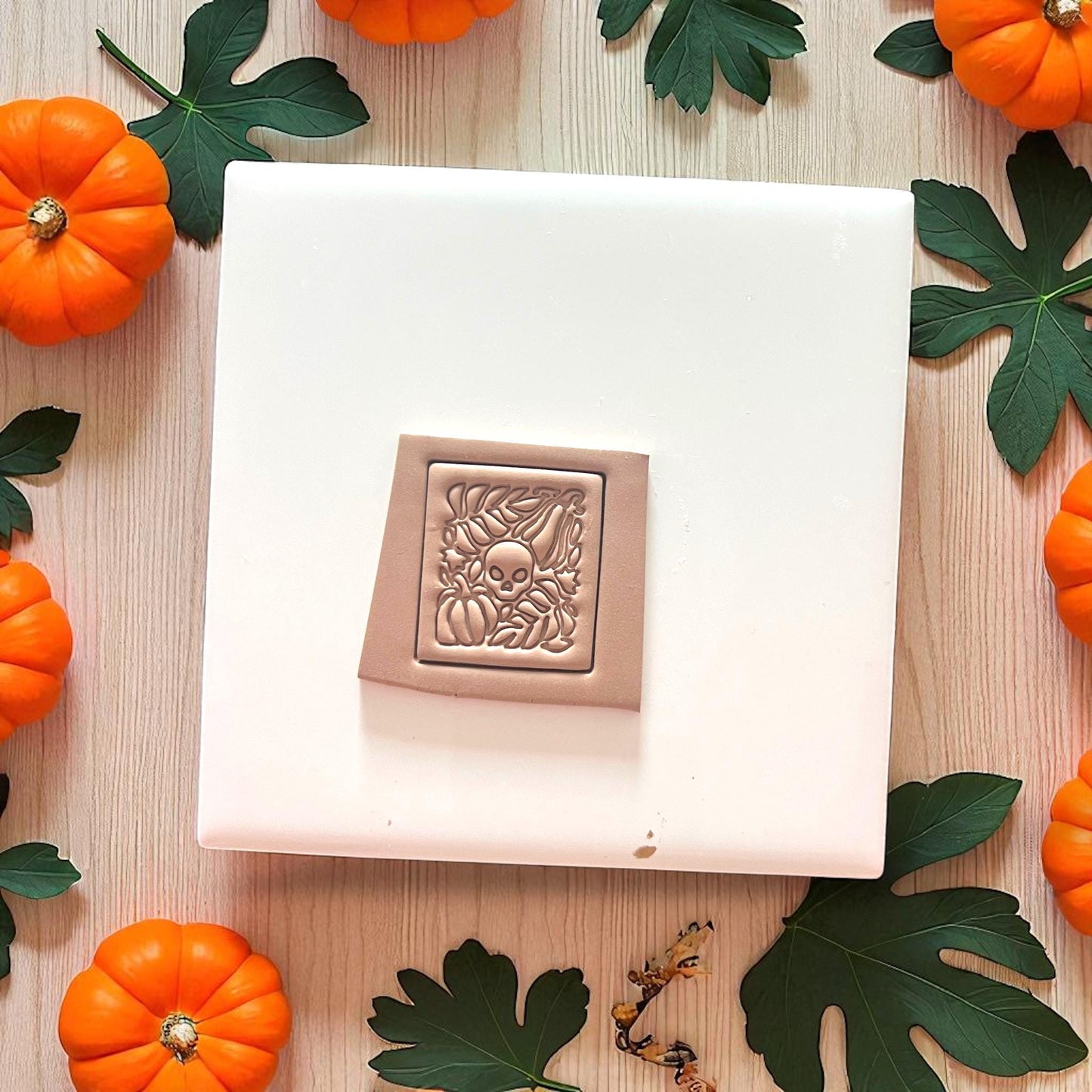 Fall-themed clay slab with skull, pumpkins, and leaves design