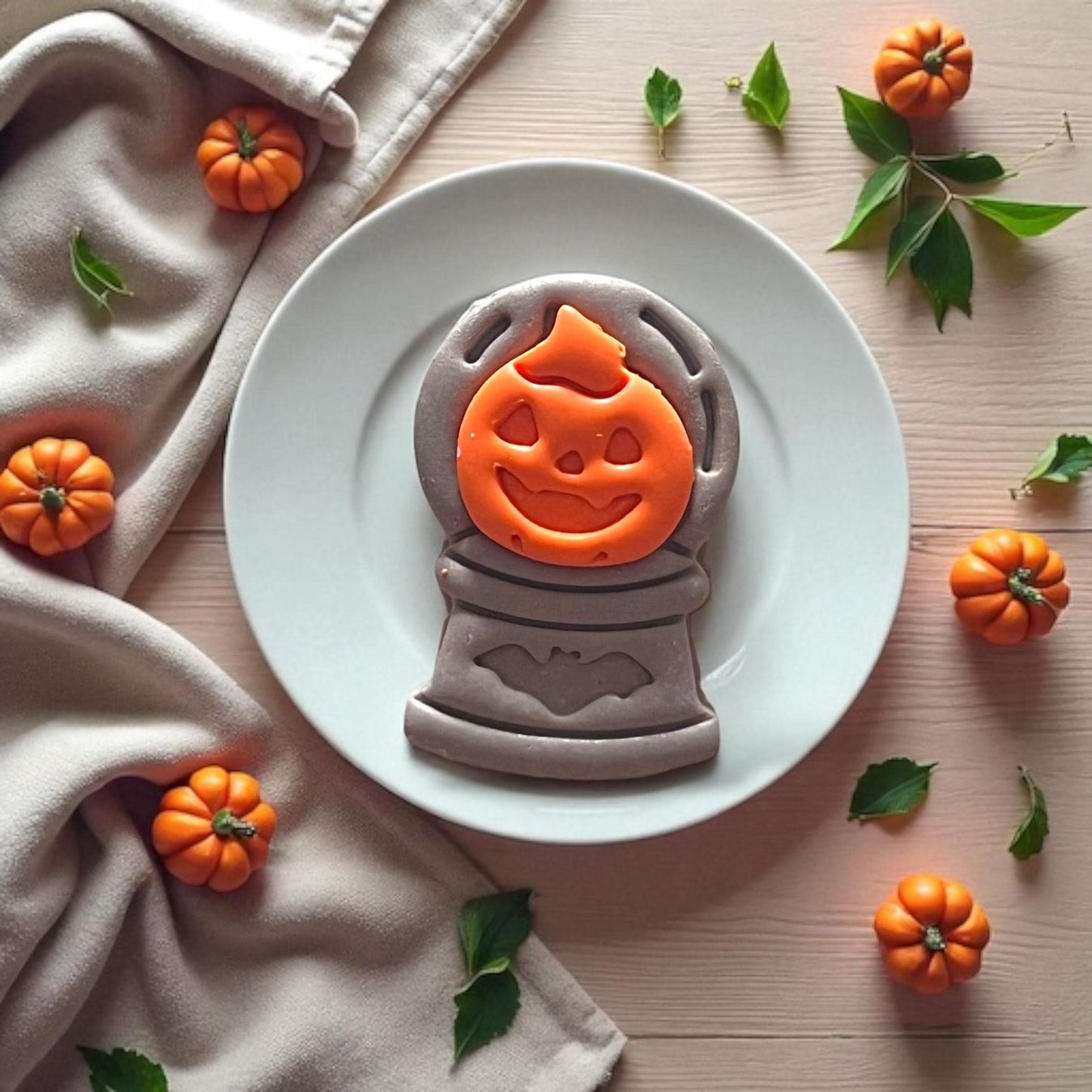 Two-piece clay impression showing pumpkin on top of crystal ball