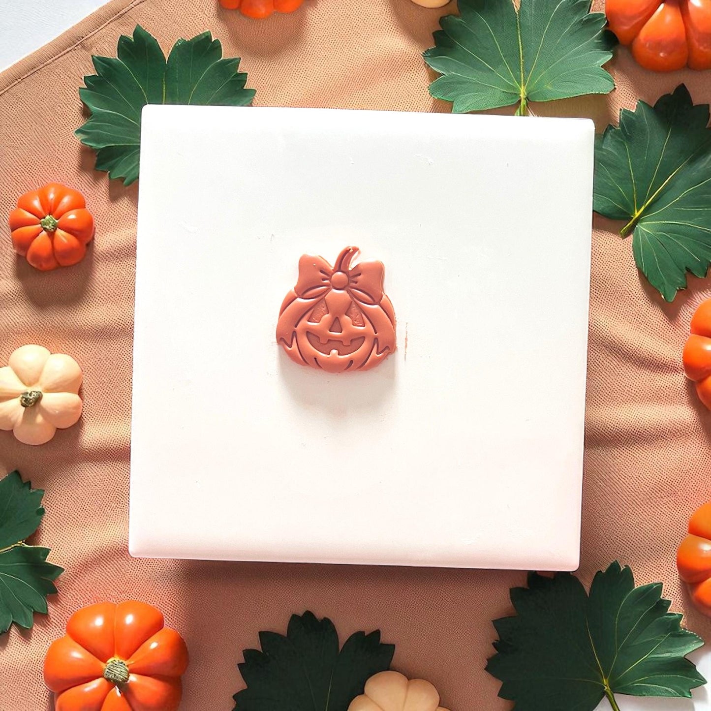 Halloween jack-o'-lantern clay imprint with bow detail