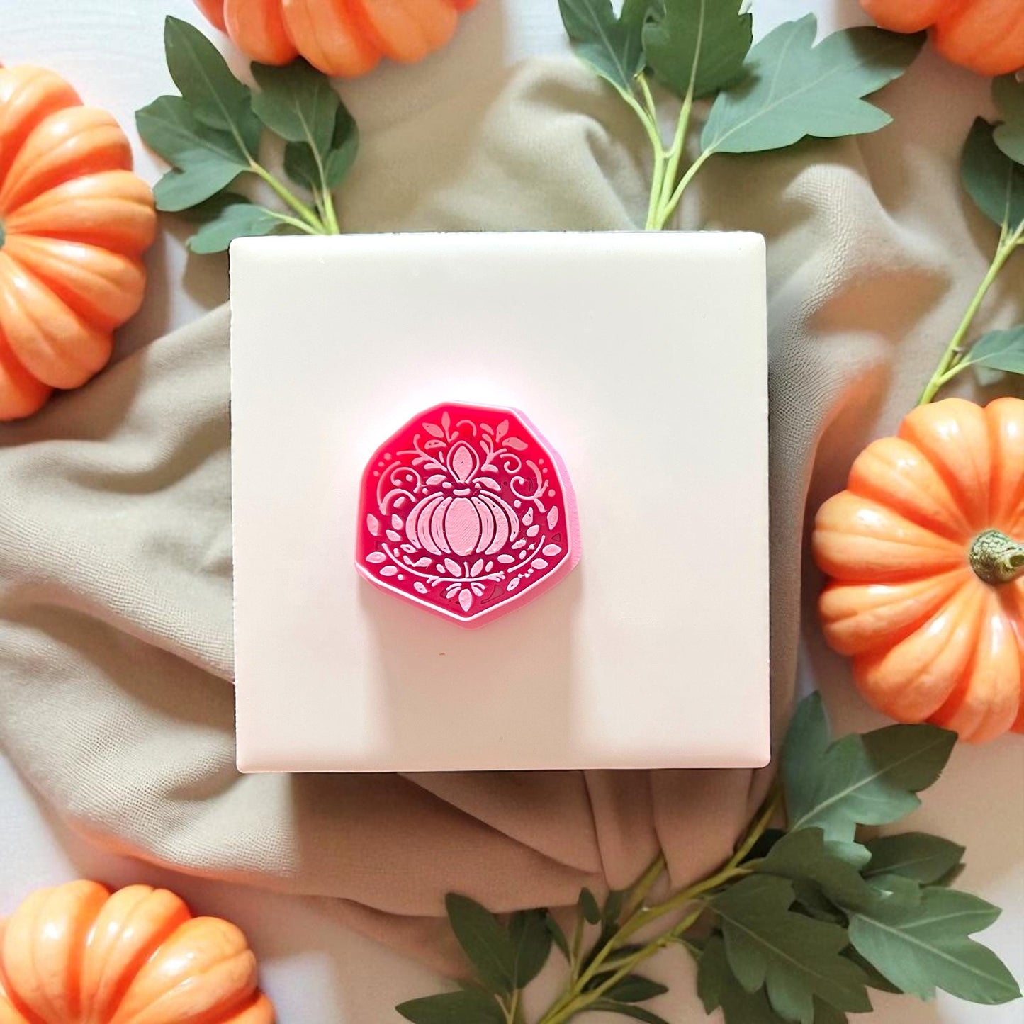 Ornate pumpkin polymer clay cutter in pink with autumn props