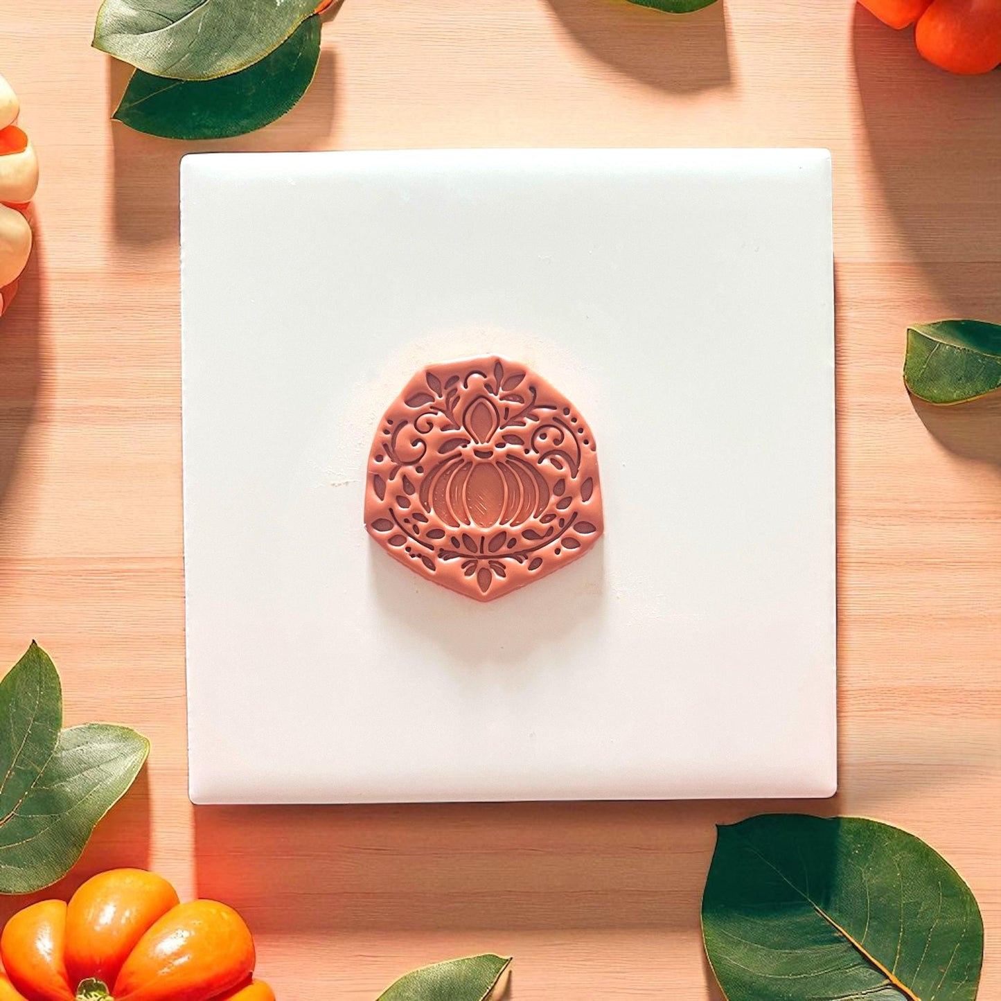 Embossed pumpkin design in clay with leaf decor