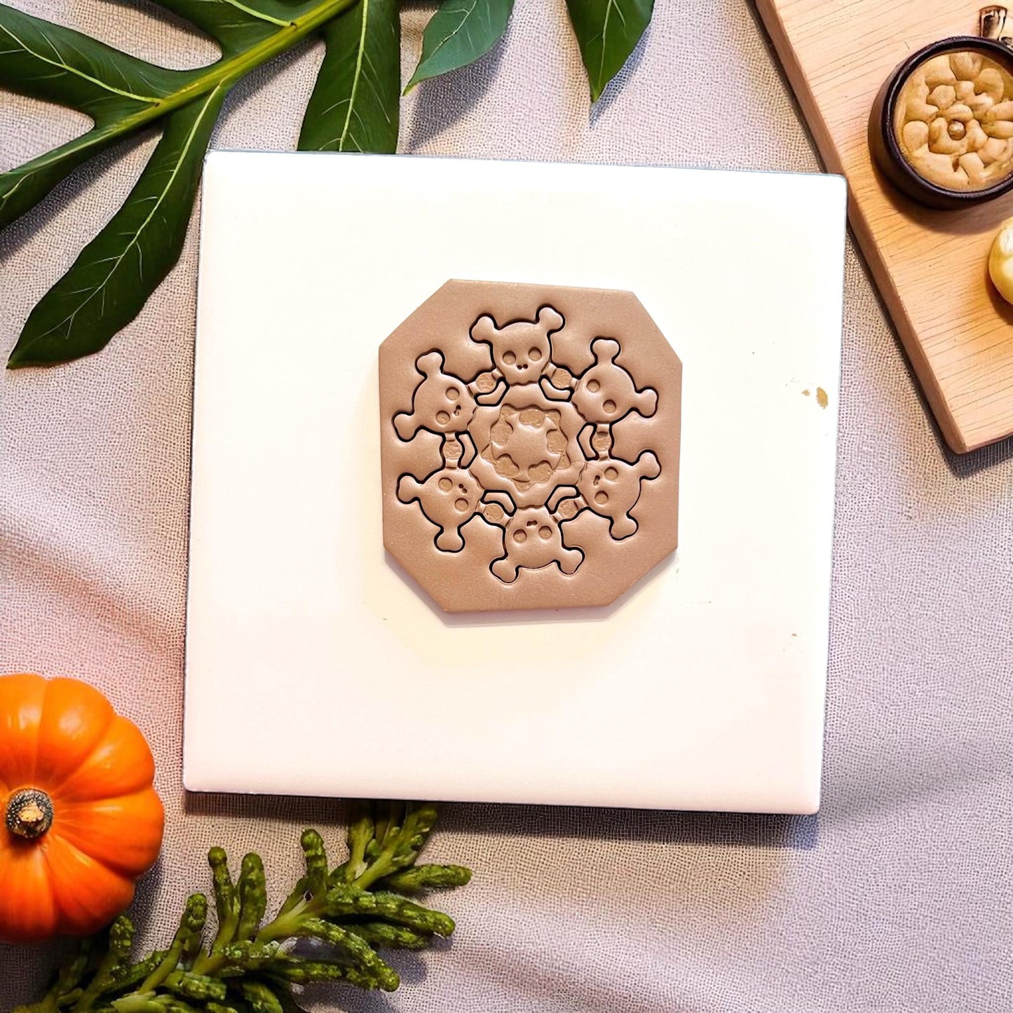 Close-up of spooky skull wreath clay design inside cutter
