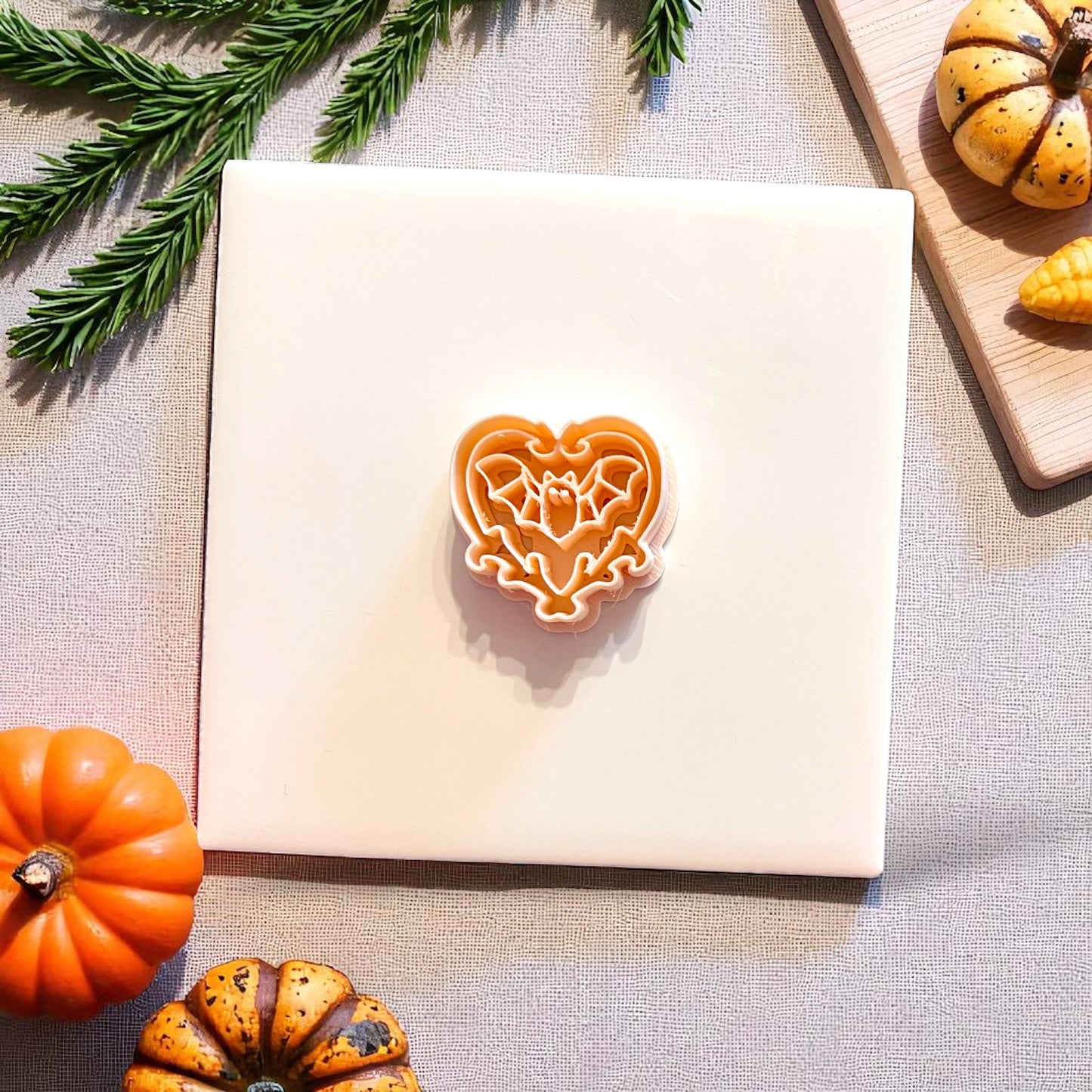 Orange polymer clay cutter in the shape of a bat within a heart