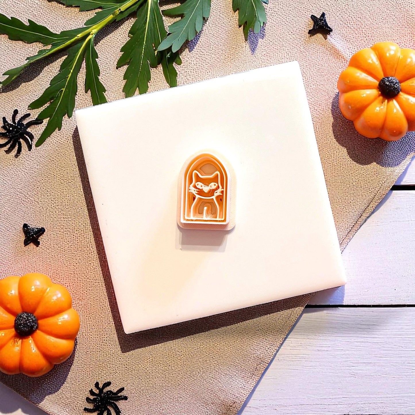 Halloween-themed cutter shown on tile with surrounding props