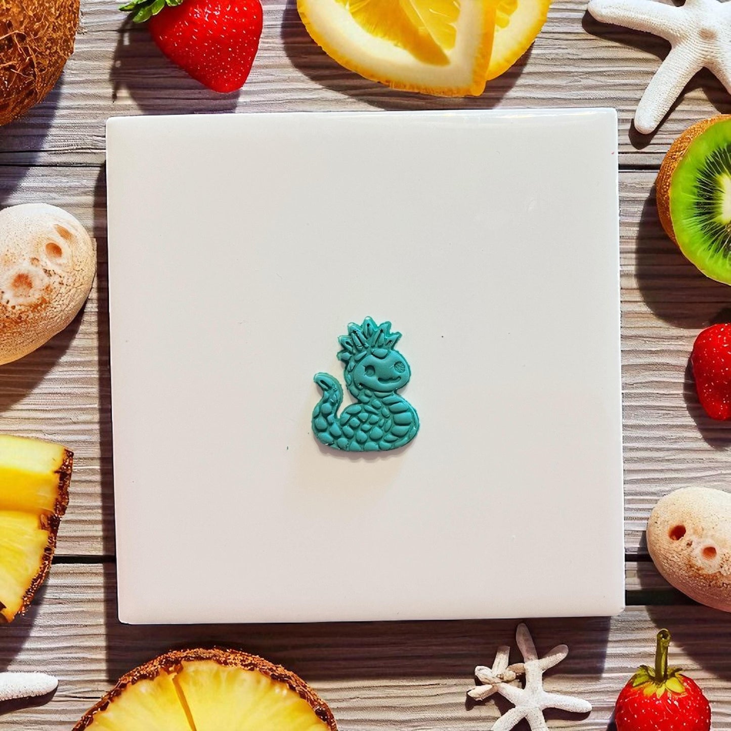 Small teal pineapple sea serpent charm