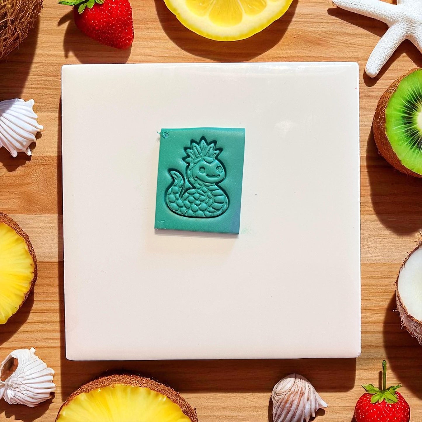 Pineapple sea serpent imprint on teal clay slab