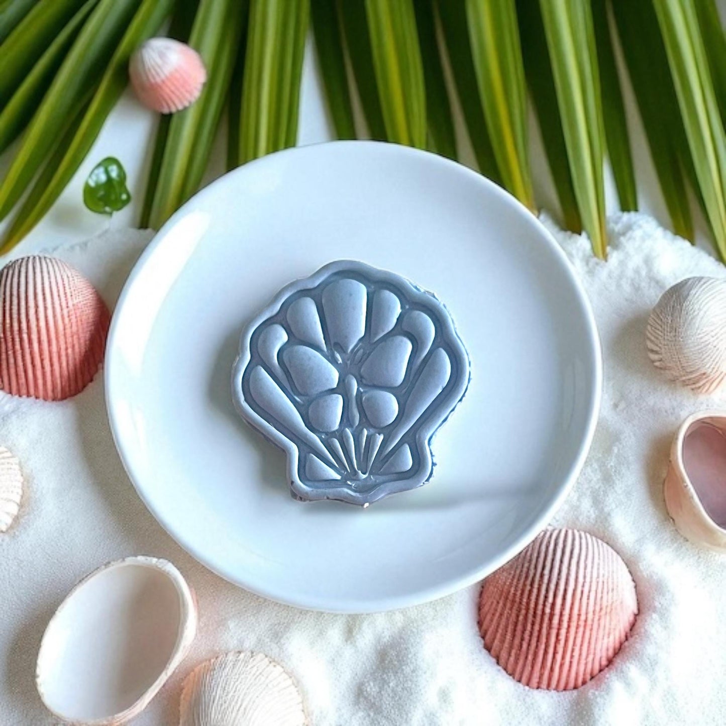 Ceramic dish showing large shell with butterfly detail
