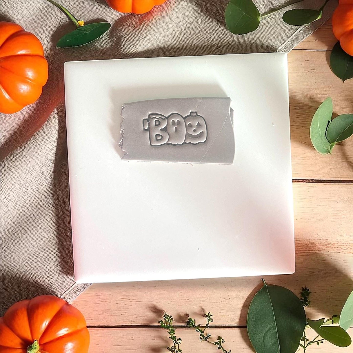 BOO word impression in clay with pumpkin and ghost design