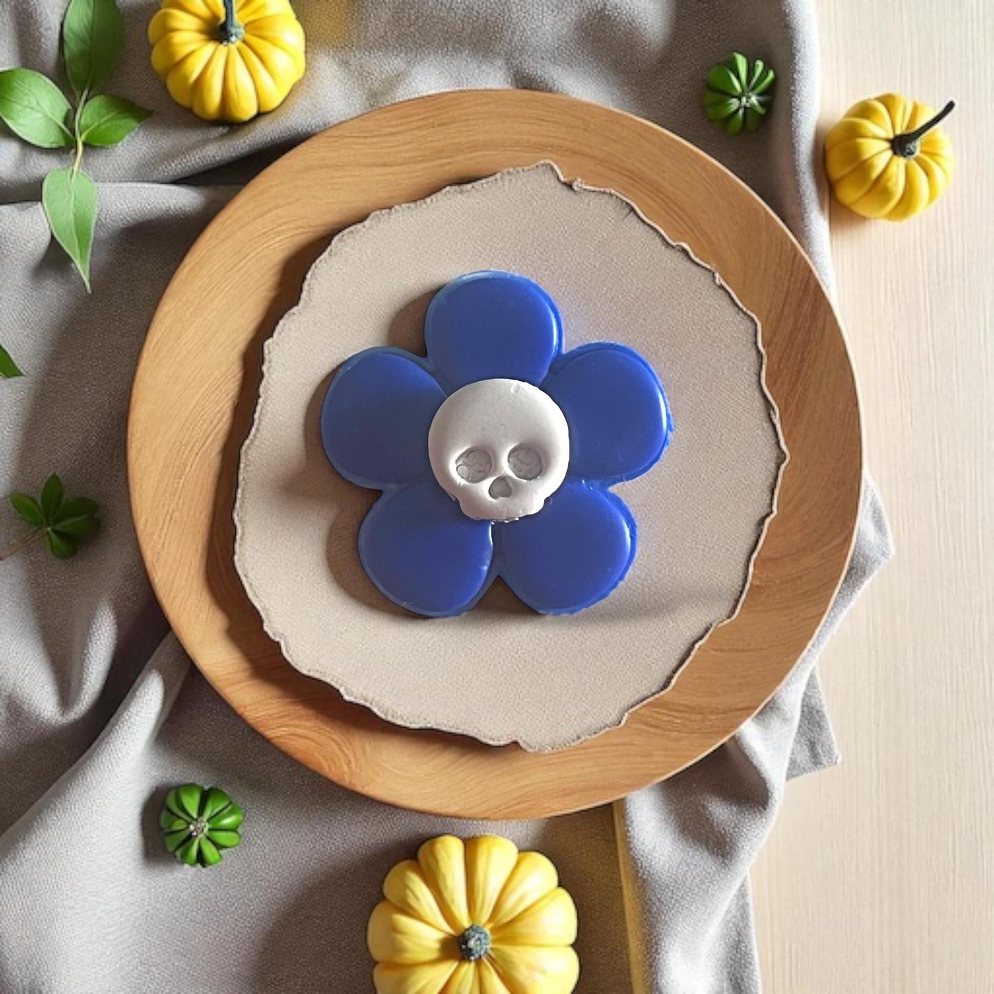 Blue flower with white skull center displayed on wood plate