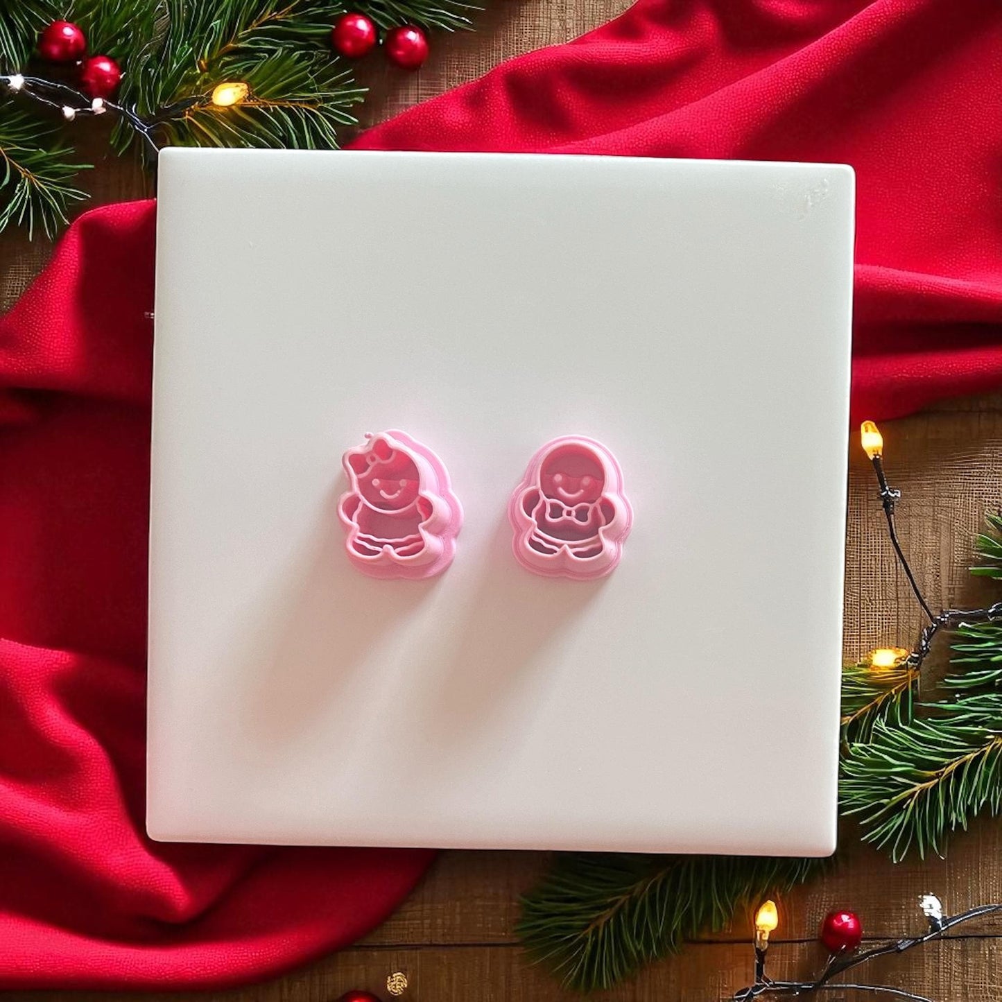 Gingerbread boy and girl cutters in festive setup