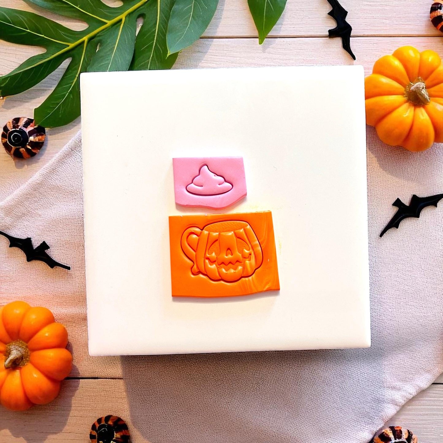 Pumpkin mug with pink whip clay impression on tile