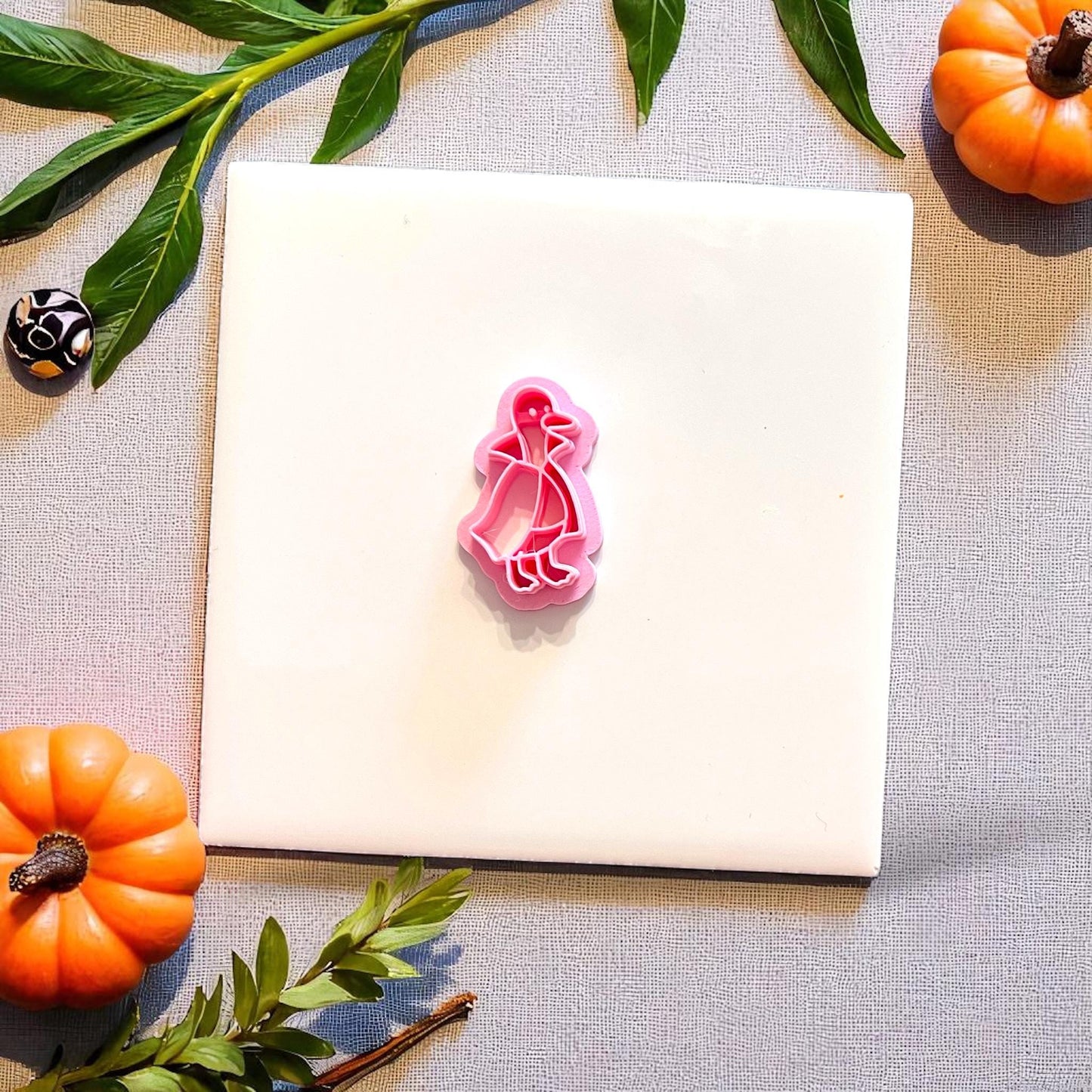 Pink Duckula cutter shown on white tile