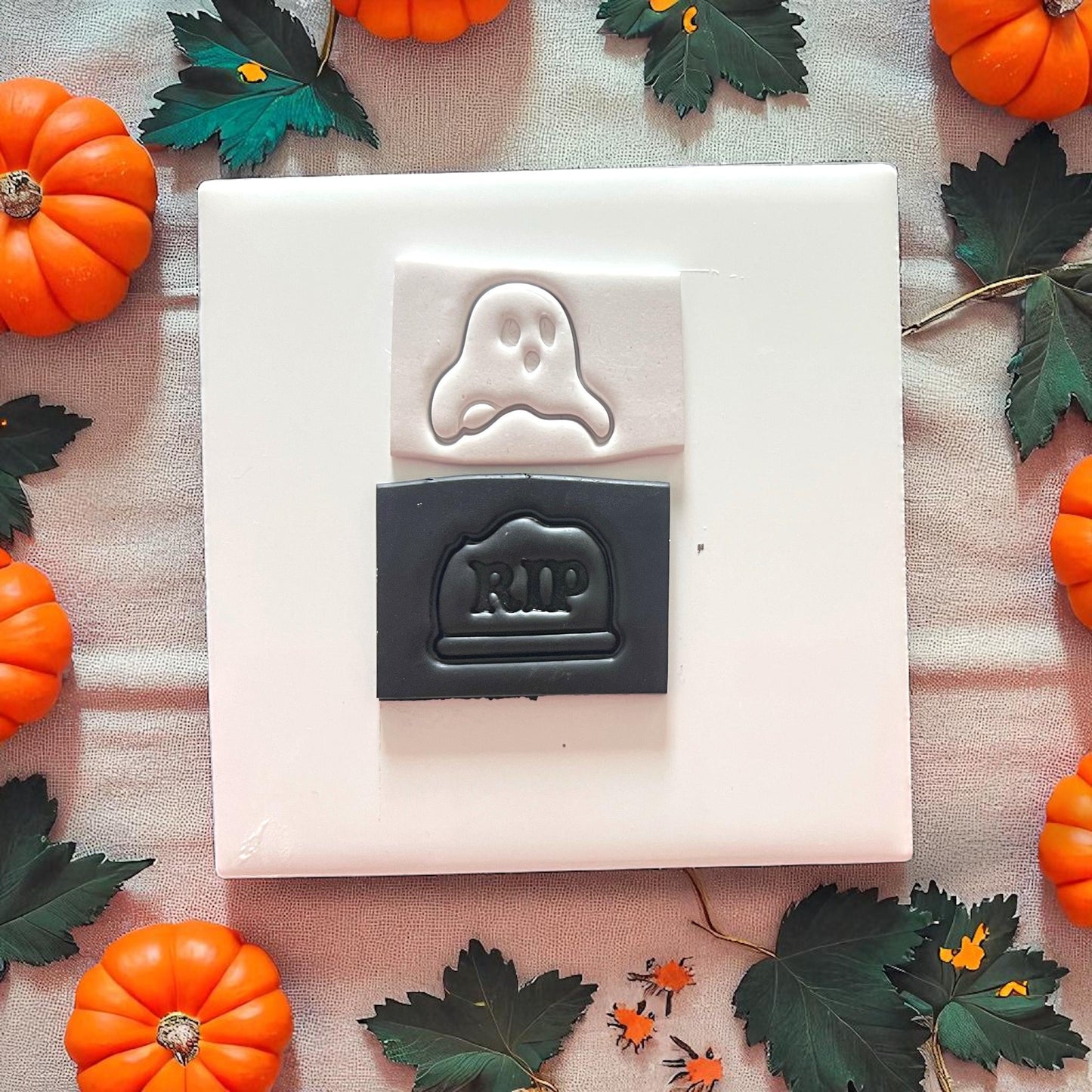 Stamped ghost and tombstone in clay slab, fall decor surrounding