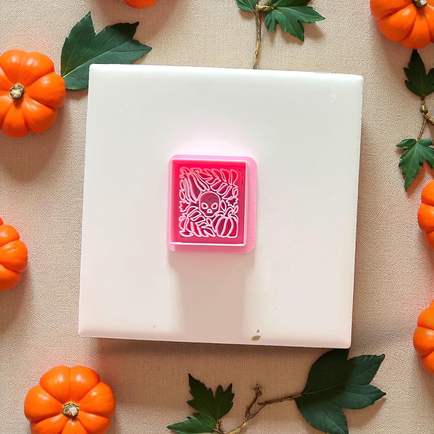 Pink Matisse skull and pumpkin polymer clay cutter on tile