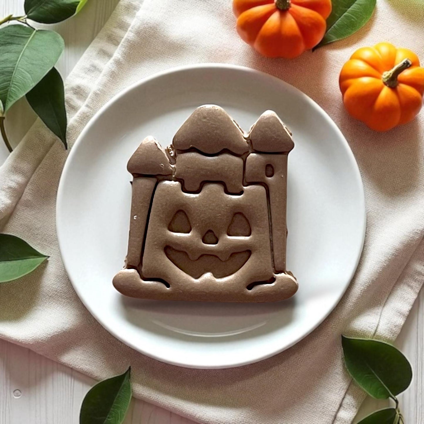 angled view of halloween castle clay piece with pumpkins