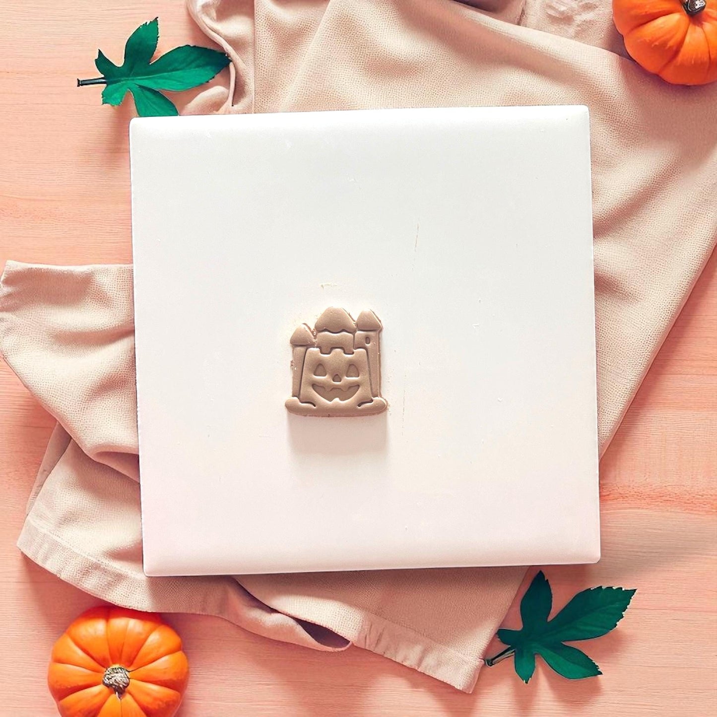 clay cutter and impression of jack-o'-lantern sandcastle