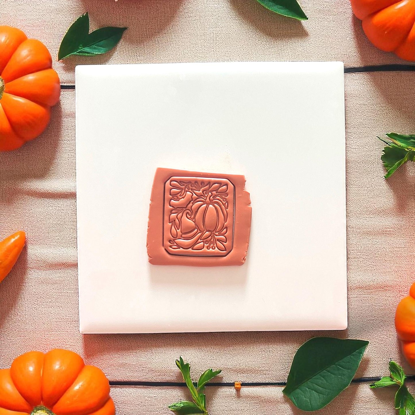 pumpkin and witch hat motif impressed into clay