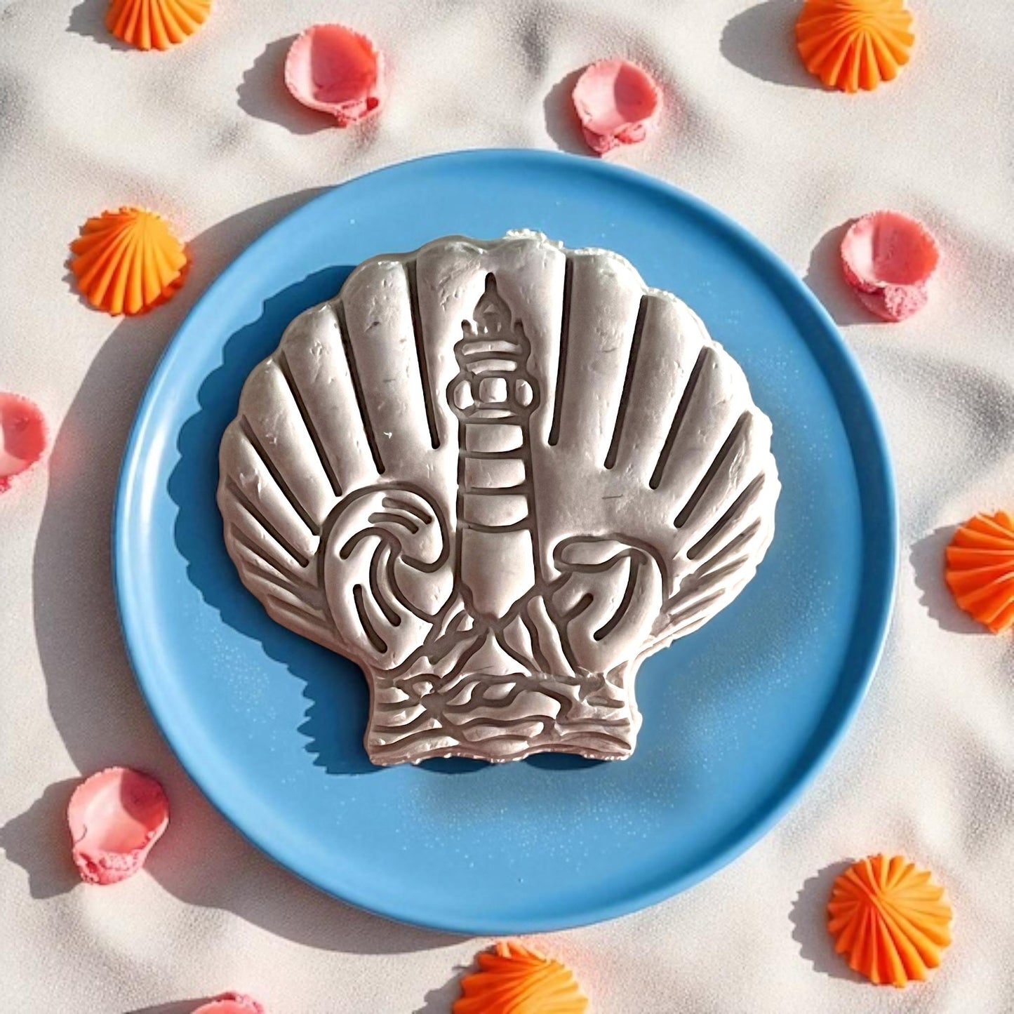 Large slab showing shell and lighthouse polymer clay imprint on blue plate