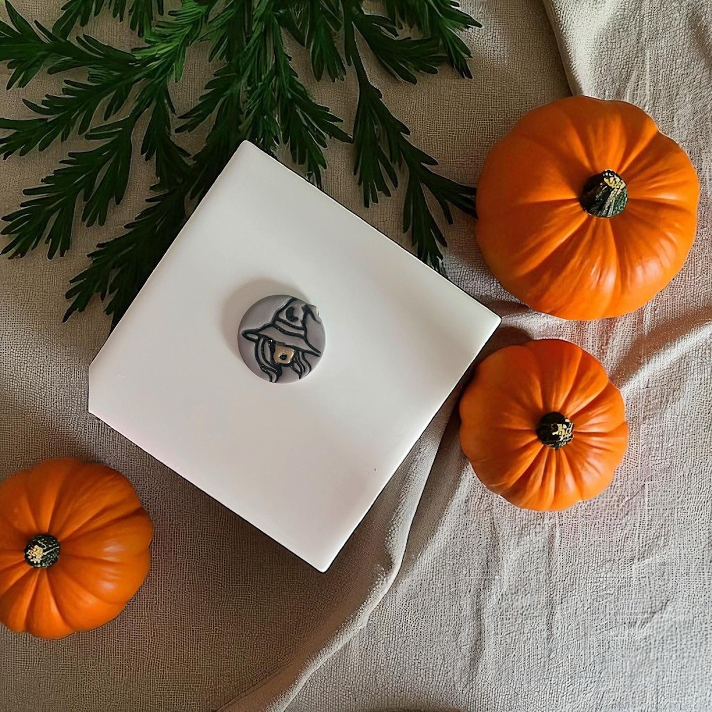 Painted sexy witch clay piece with orange pumpkins and greenery