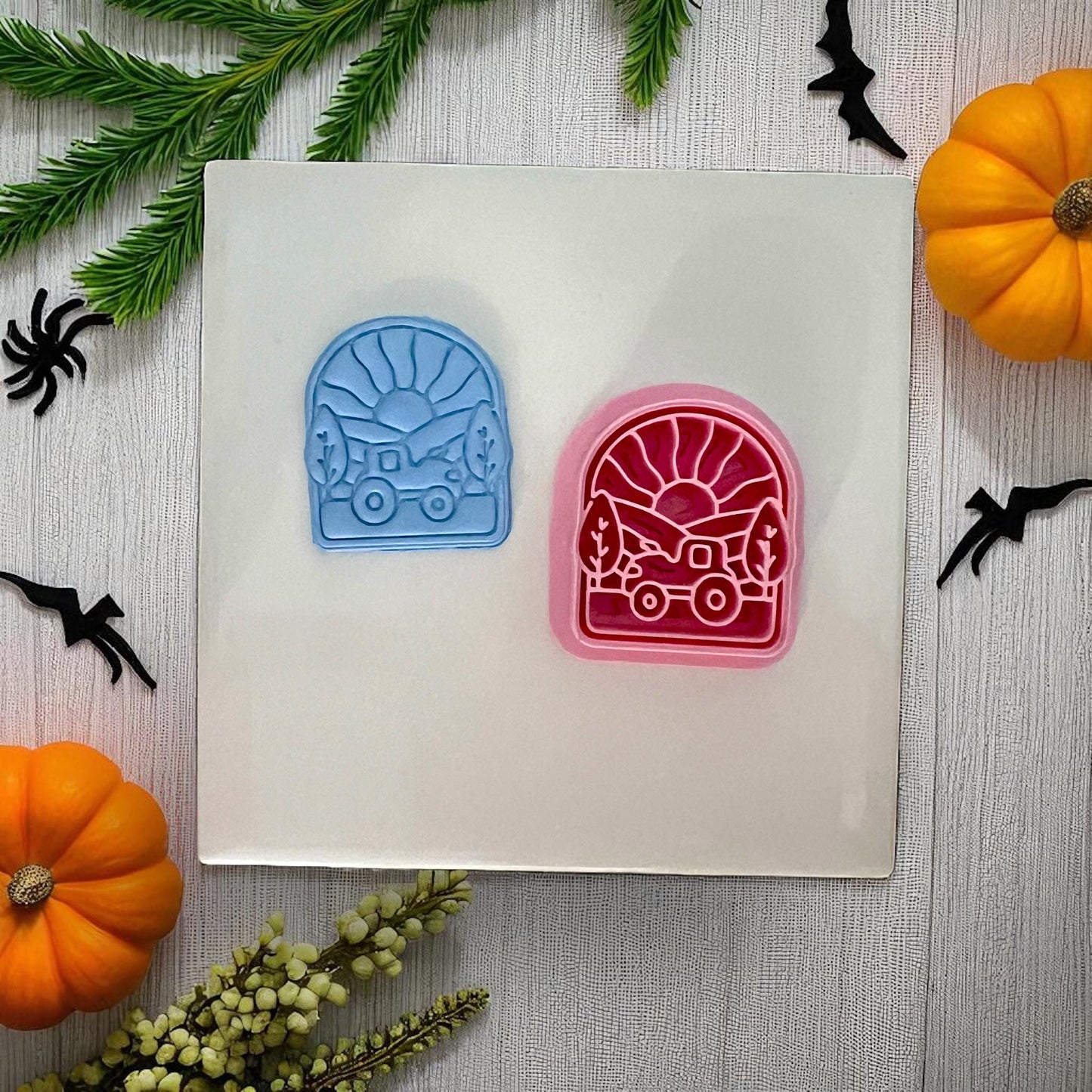 Two tractor sunset clay cutters in blue and pink with Halloween decor