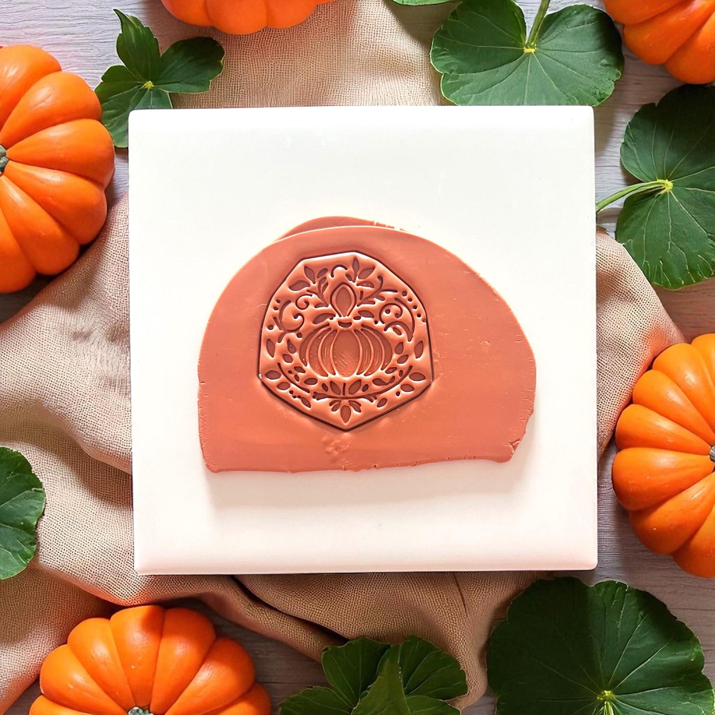 Stamped ornate pumpkin in uncut clay slab