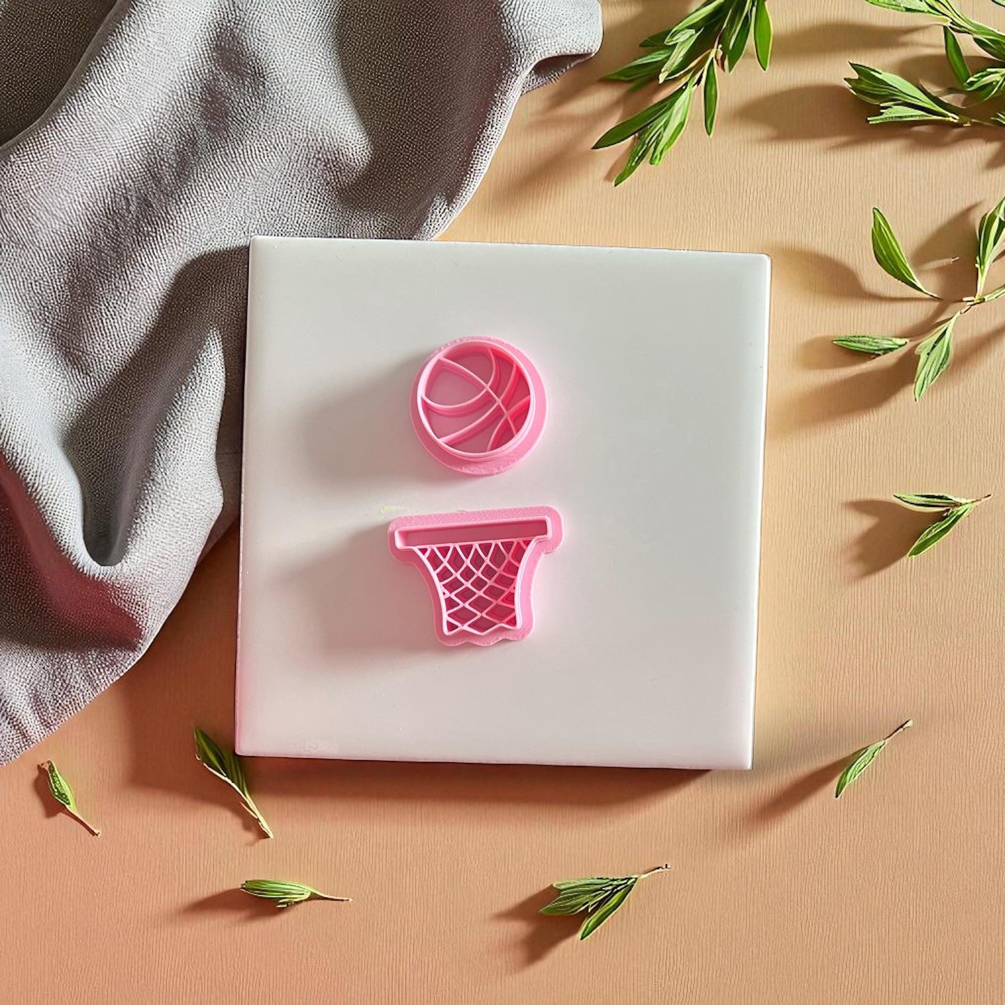 pink basketball and hoop cutters on peach background