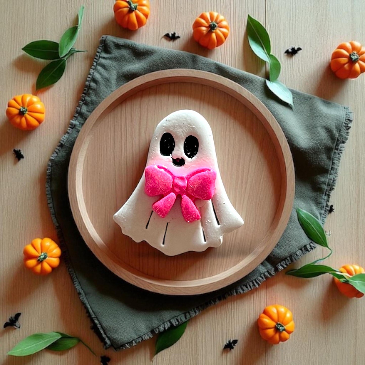 Finished ghost with bold pink bow styled with mini pumpkins
