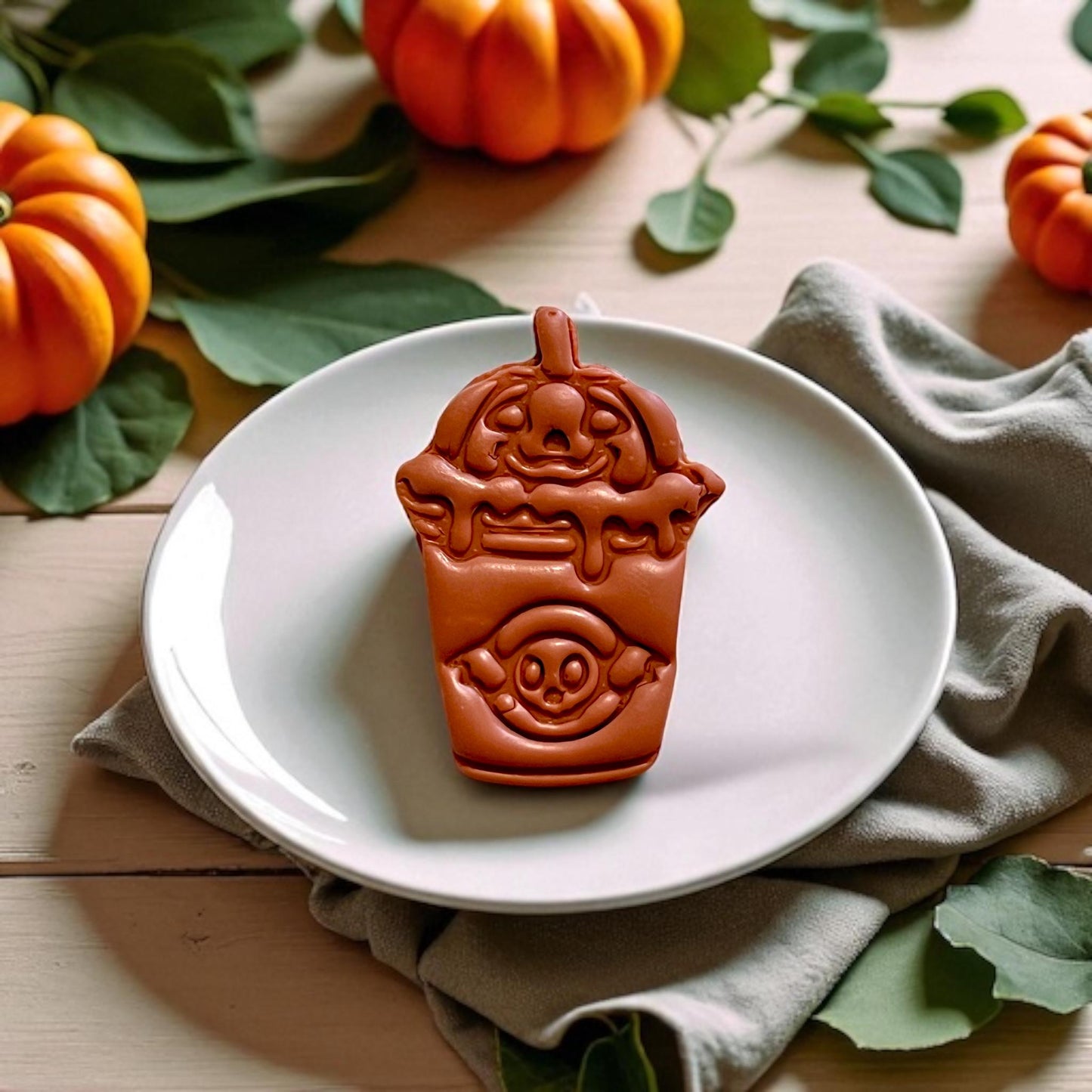 Finished boba drink clay design styled on white plate with spooky fall theme