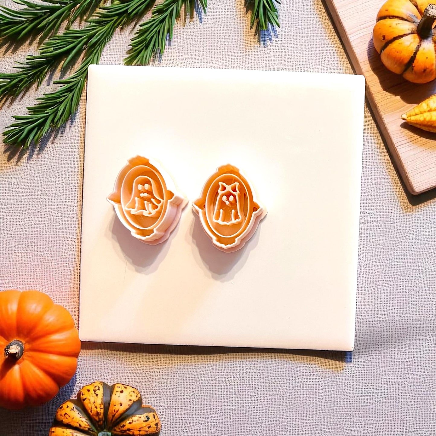 Top view of Mr. and Mrs. ghost portrait cutters placed on white tile with Halloween decor