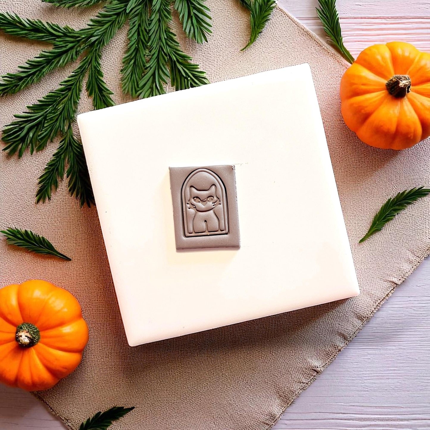 Close-up of polymer clay slab with spooky cat design inside arched frame