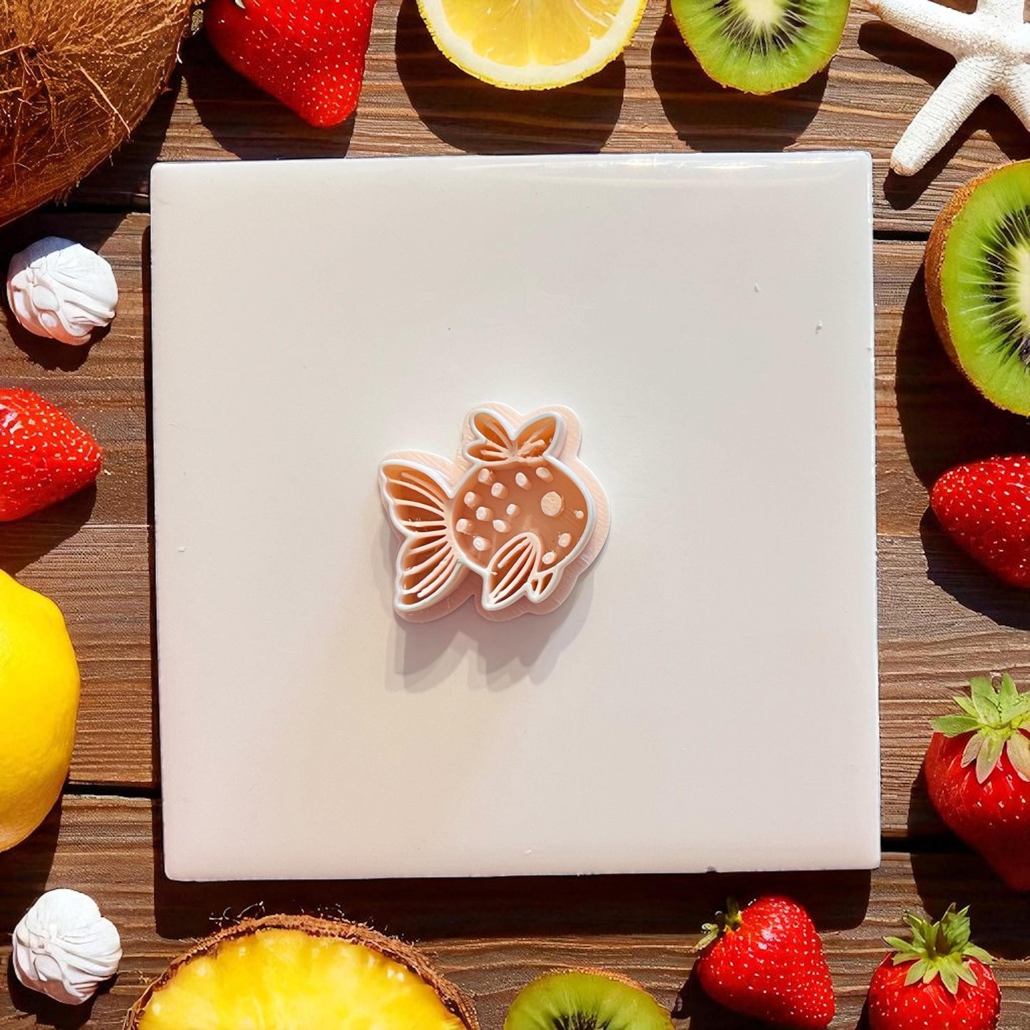 Fruit-inspired fish clay cutter with layered detail shown on tile