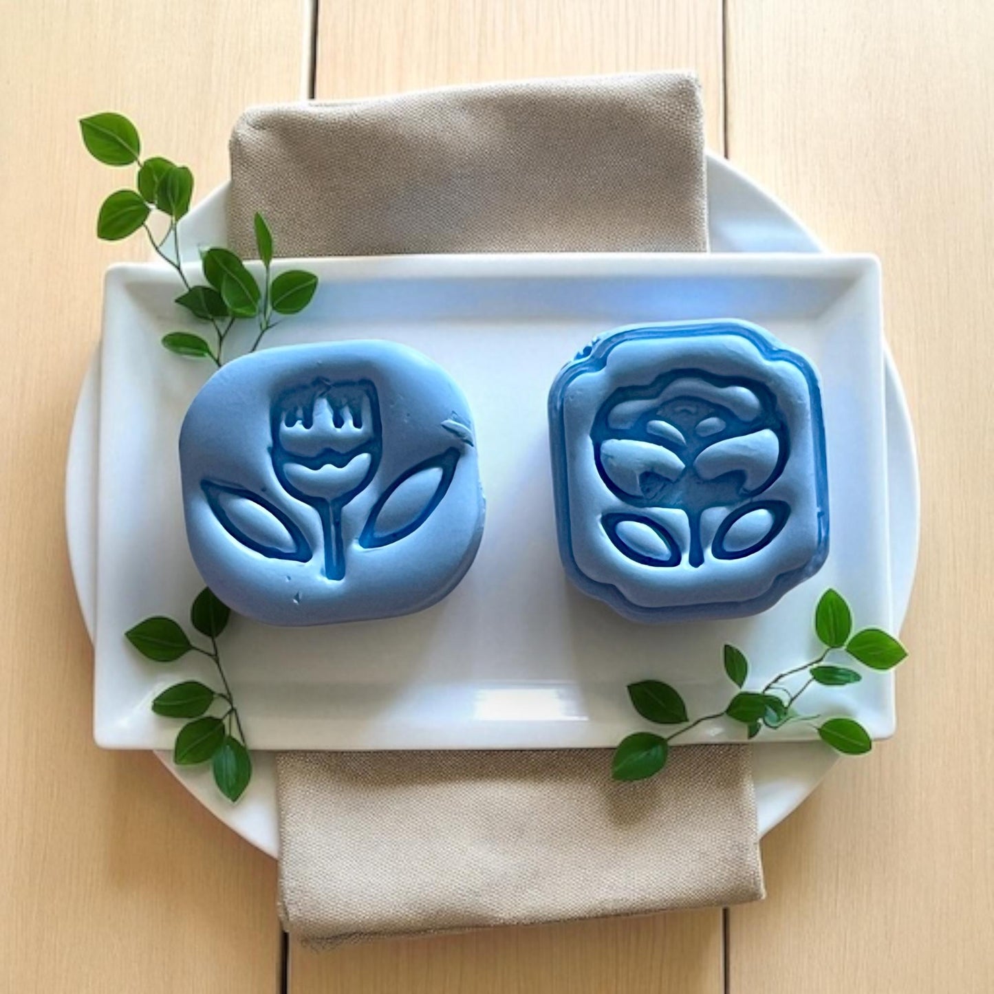 closeup of clay impressions on plate with greenery