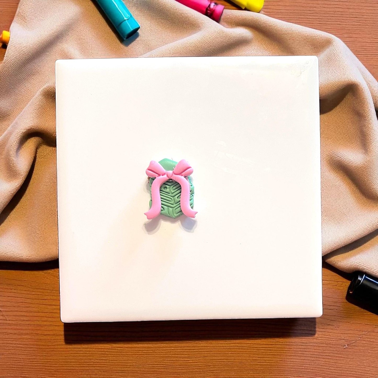 bow clay impression next to book