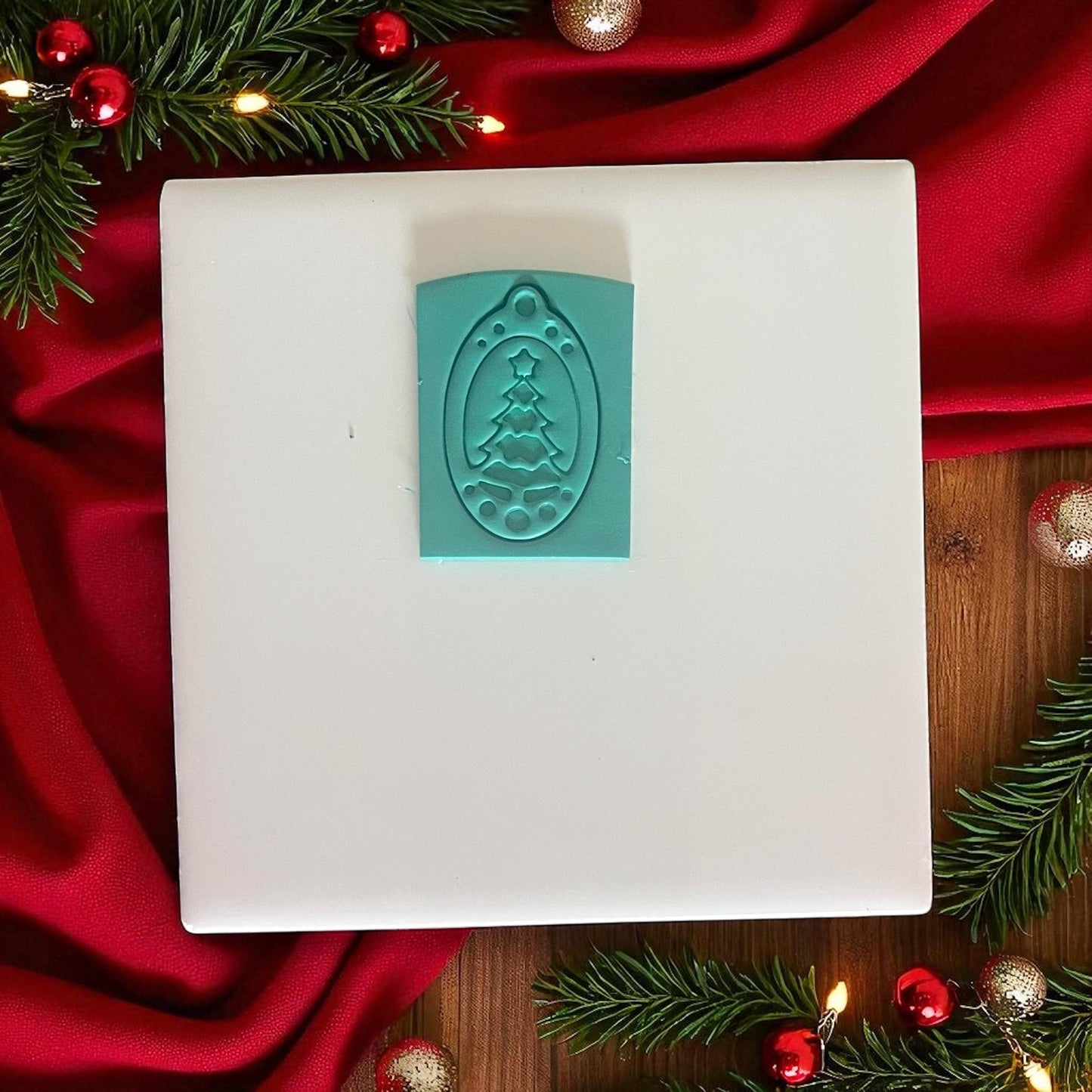 Green polymer clay slab with Christmas ornament tree cutter impression