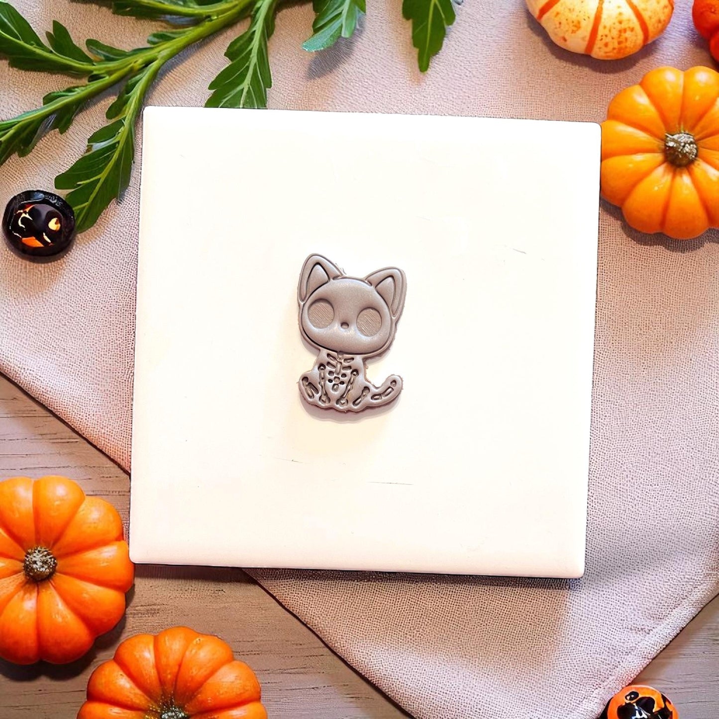 Finished spooky cat skeleton clay piece shown on display