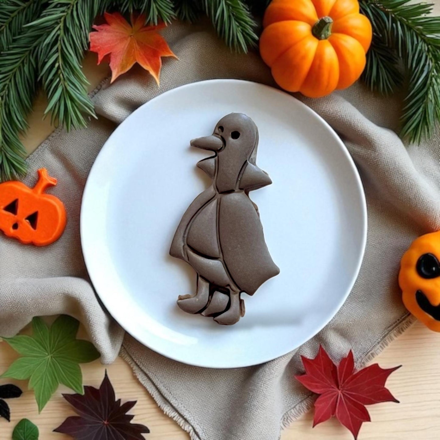Finished Duckula cookie styled on plate with fall decor