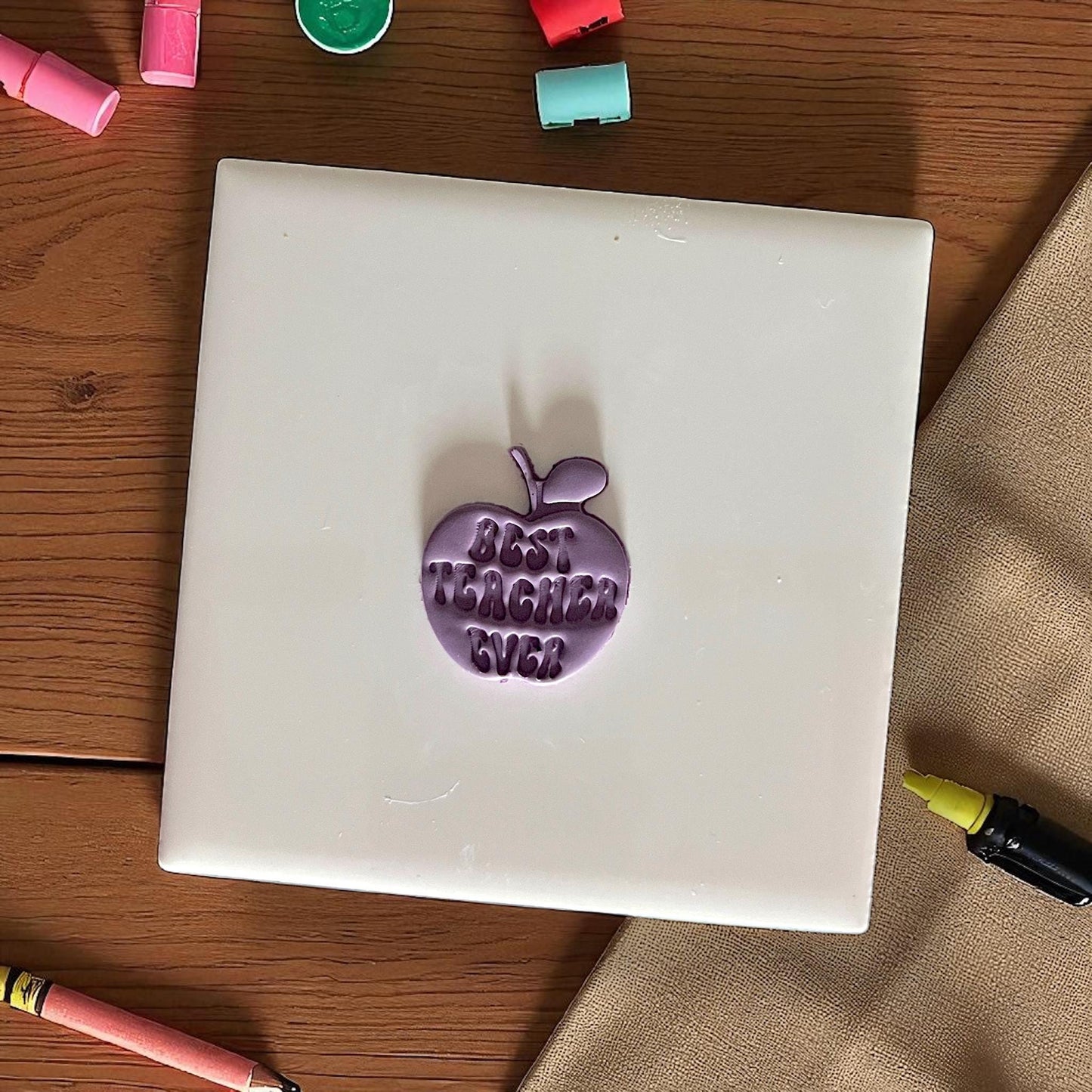 best teacher ever apple clay impression on purple clay circle on white tile