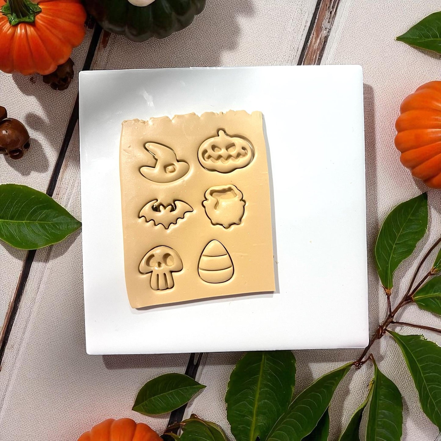 Clay slab with six Halloween shapes pressed in