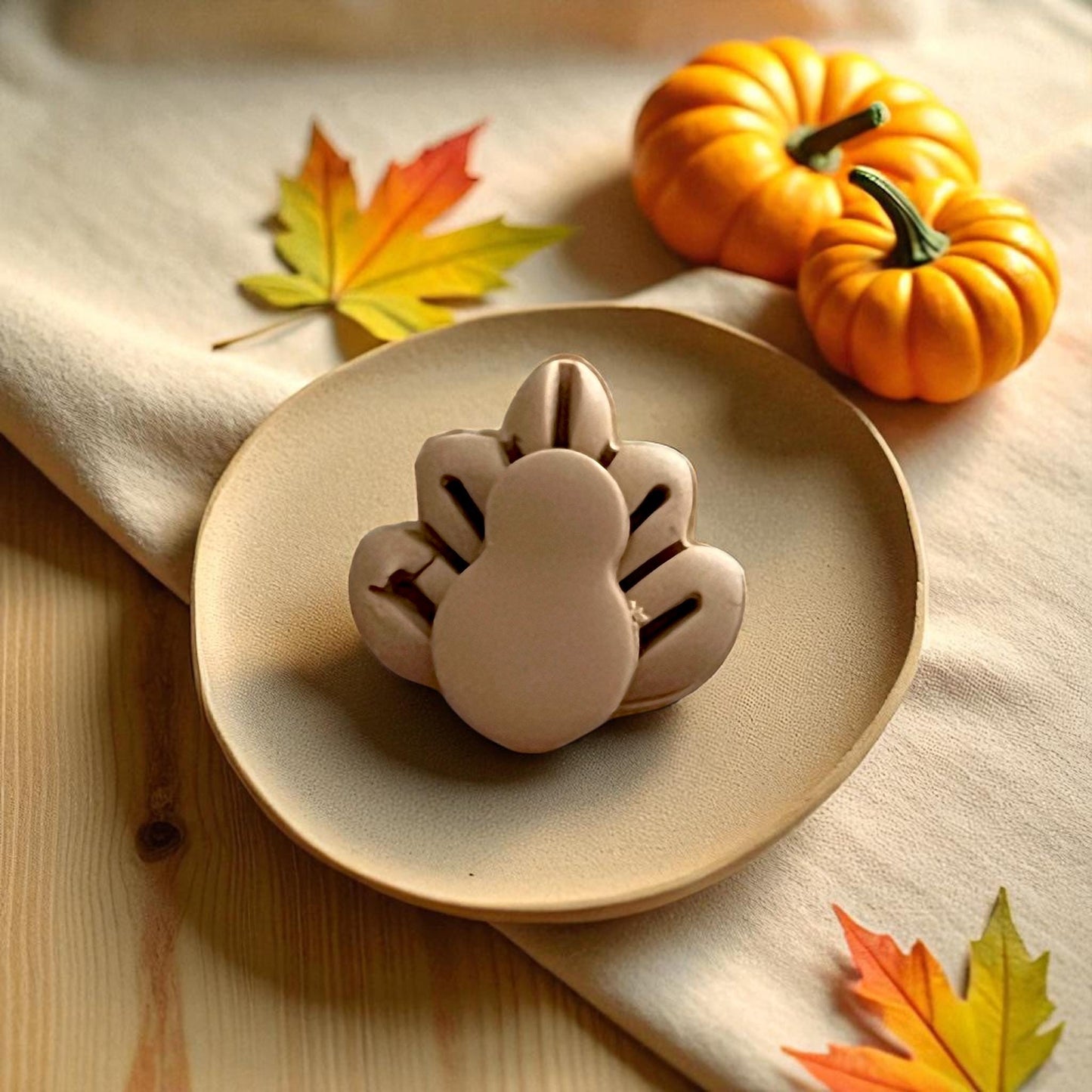 Thanksgiving turkey clay cutters displayed on white tile with pumpkins and yellow leaves
