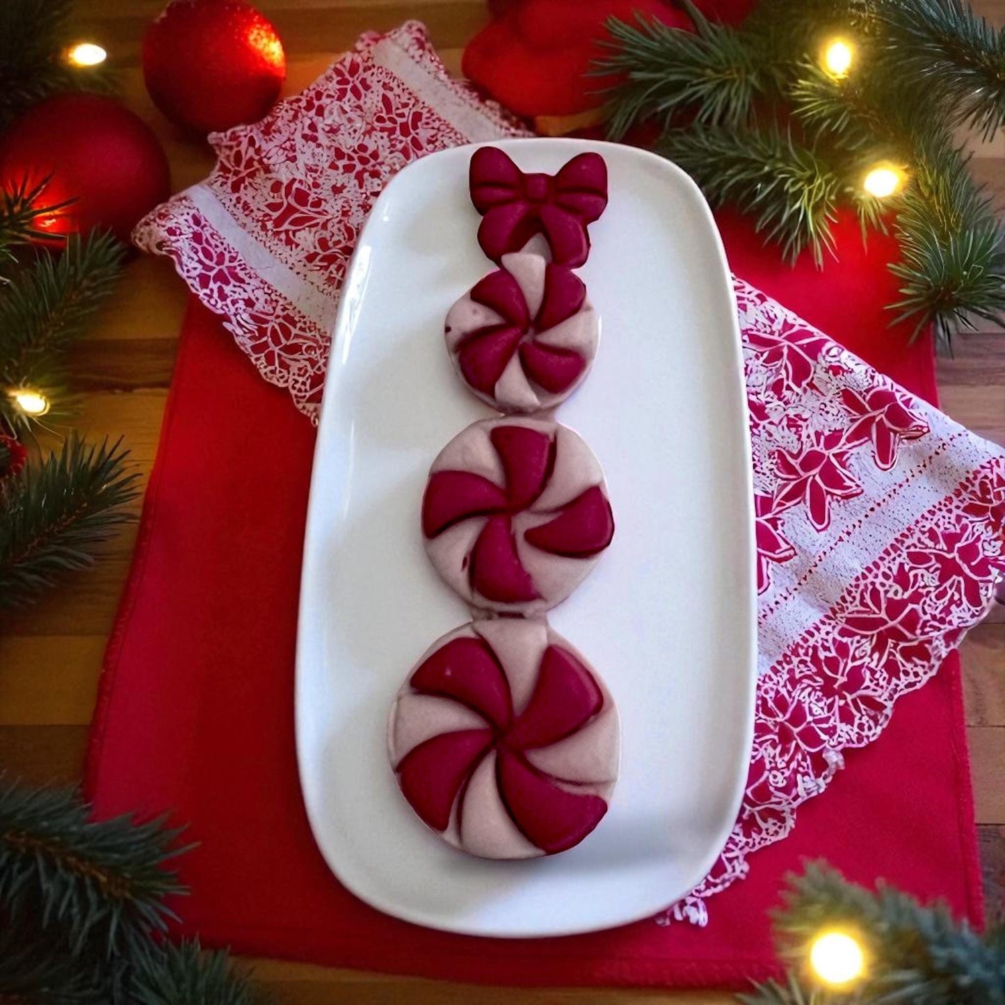 Peppermint snowman clay stack with bow on white tray and red holiday napkin