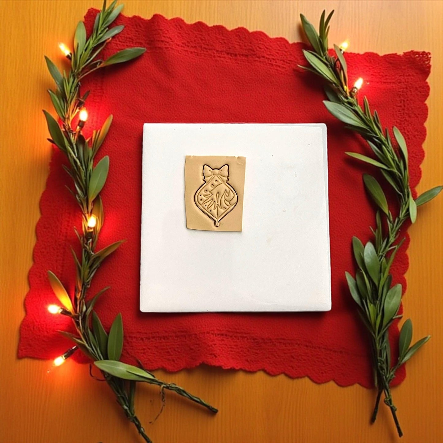 Grinch ornament polymer clay imprint with bow and candy cane on tan clay