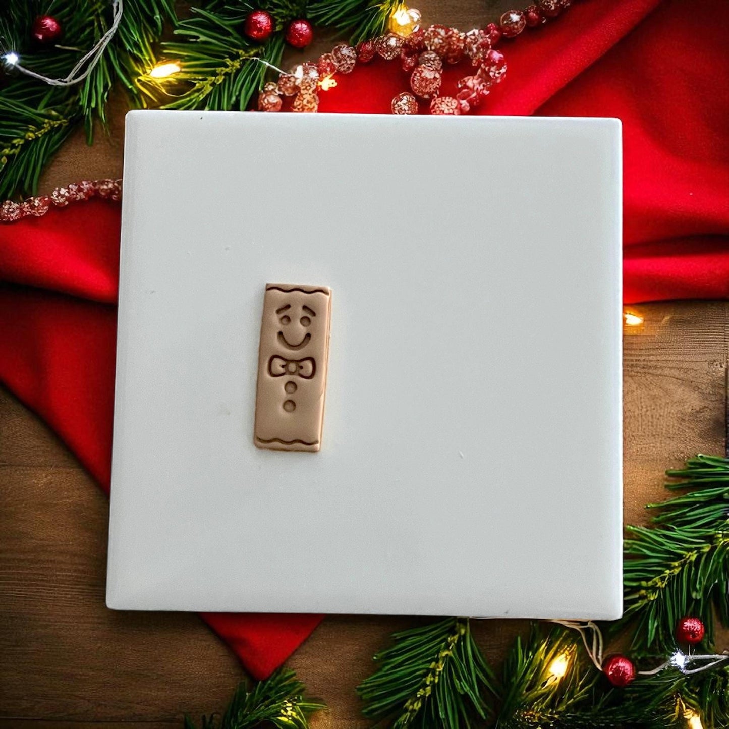 Gingerbread bar clay impression and cutter side by side on festive holiday backdrop