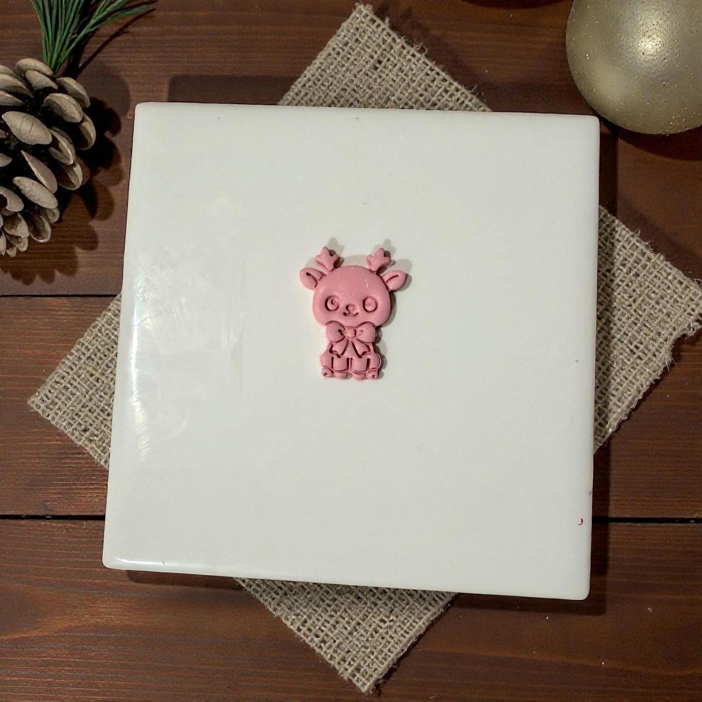 pink reindeer clay piece centered on tile