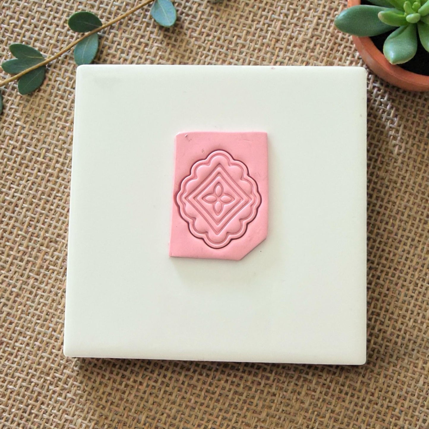 rectangular pink clay tile with scalloped diamond design